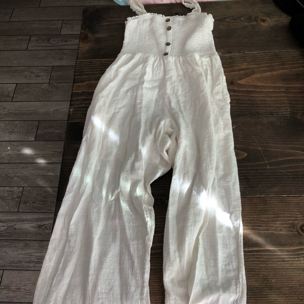 white jumpsuit with buttons down the front